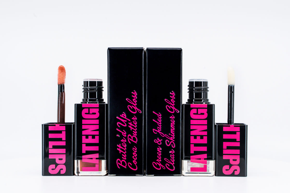 Butter'd Up and Green & Jaded glosses open beside their black cartons.